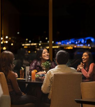 table of 4 dining in Aura Waterfront Restaurant + Patio