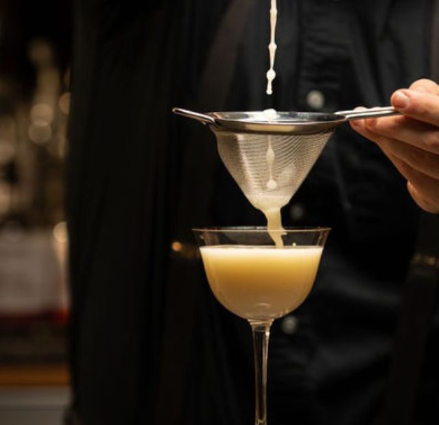 bartender preparing a cocktail at the bar